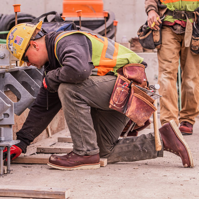 A man wearing Chippewa Edge Walker Moc Toe 6" Boot in Briar Haystack (brown). 